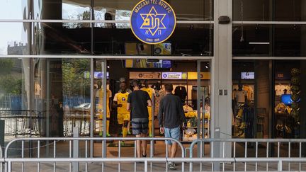 Deux hommes entrent dans un magasin officiel de l'&eacute;quipe de football isra&eacute;lienne Maccabi Tel Aviv, au stade Bloomfield de Tel Aviv, le 8 novembre 2024. (JACK GUEZ / AFP)